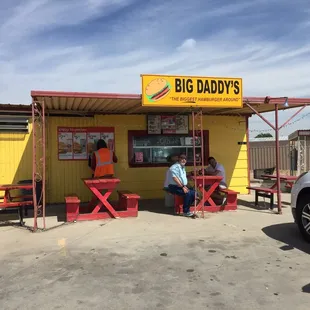 a man sitting outside of a restaurant
