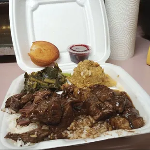 Beef Tips over White Rice, Collard Greens and Dressing with Gravy Cornbread Muffin and Cranberry Sauce