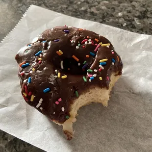 a chocolate frosted donut with sprinkles