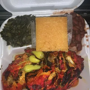 Chicken dinner with collard green and red beans and rice.