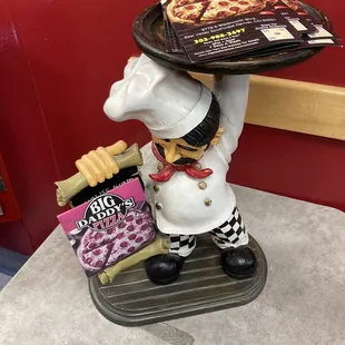 a chef holding a tray of pizza
