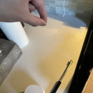 a person's hand drawing on a piece of paper