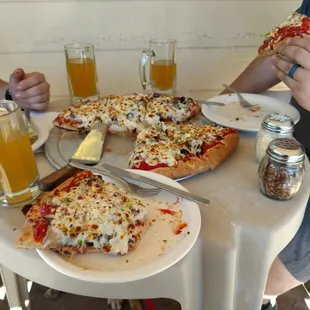 a couple of people eating pizza