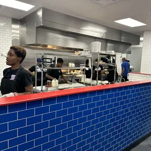 Workers getting those sandwiches out