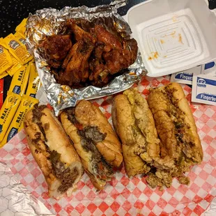 10 wings (Mardi Gras, $10.75), two Dave&apos;s Way cheesesteaks (beef and chicken, $12.99 each). You think they gave us enough condiments, naps?