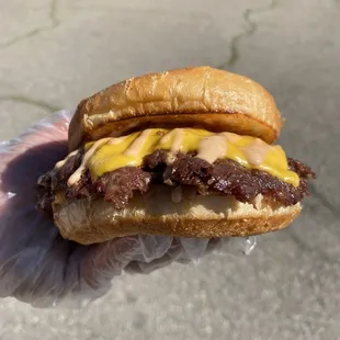 a hand holding a sandwich