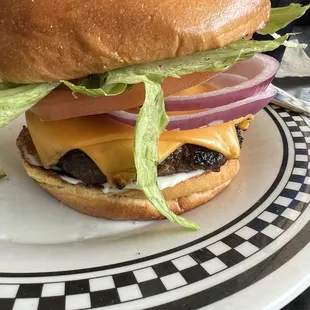 Average sized burger made so thick by all the toppings.