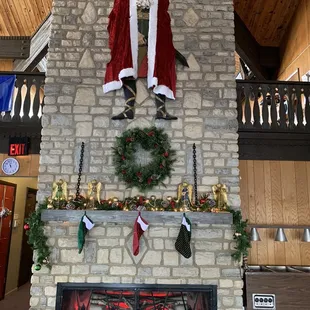 santa sitting on a fireplace