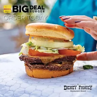 a person holding a hamburger