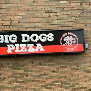 a sign on the side of a brick building