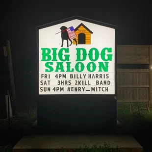 a dog standing in front of a sign