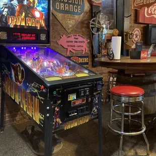 a pinball machine and stool