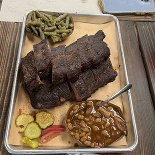 Full rack of ribs, baked beans, and green beans.