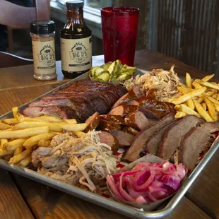 a platter of meat and french fries