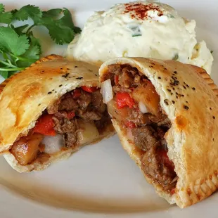 Lomo saltado empanada, beef, potatoes, sundry tomatos and onions.