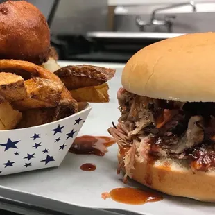 a pulled pork sandwich and french fries