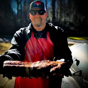 a man holding a large piece of meat