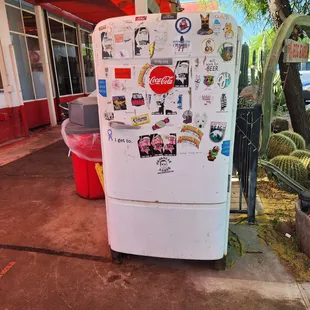 a refrigerator covered in stickers