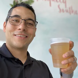 a man holding a cup of beer