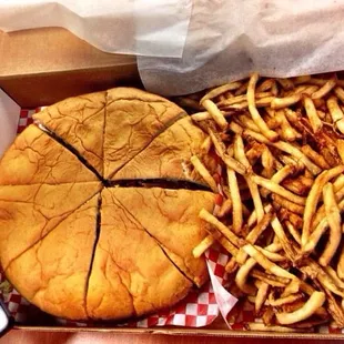 Huge burger with fries.