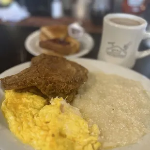 Fried pork chops , scrambled eggs and Grits