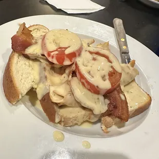 Turkey Devonshire-shaved cold lunch meat, 1 strip of bacon, untoasted white bread, overly ripe tomato, and a bit of cold cheese sauce. $21