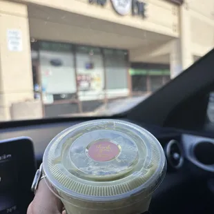a hand holding a cup of coffee