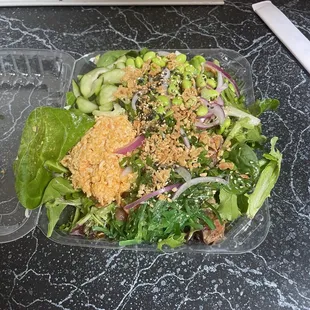 Large poke bowl with garlic tuna and salmon with a salad base.