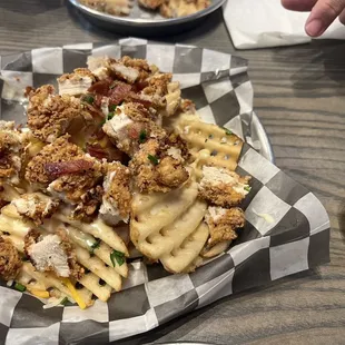 Loaded clucker fries smothered in white queso