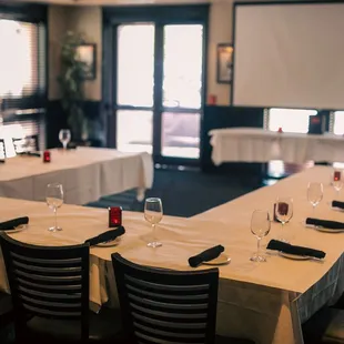 a long table with empty wine glasses