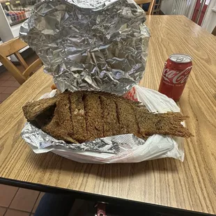 a person holding a can of soda
