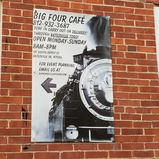 a train on the side of a brick building