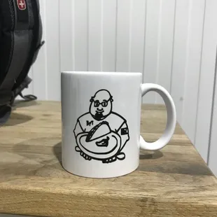 a coffee mug with a drawing of a man on it