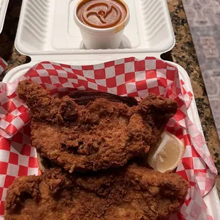 Fish cooked in dirty oil, causing meat not to be thoroughly cooked.
