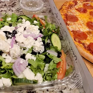 a salad and a pepperoni pizza