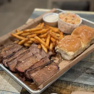 ows a tray of meat and fries