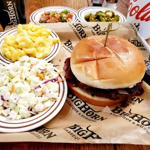 a hamburger, coleslaw, macaroni and cheese