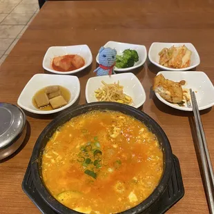 a bowl of soup and plates of food