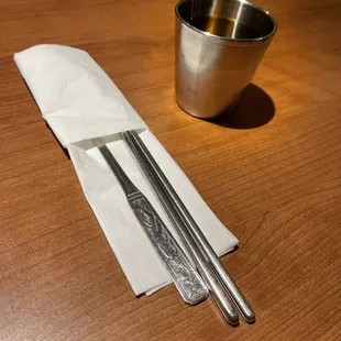 a spoon and two forks on a table