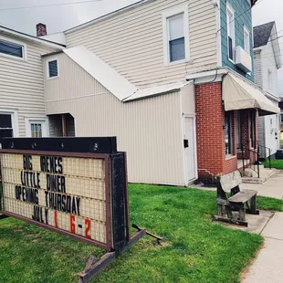 a sign in front of a house