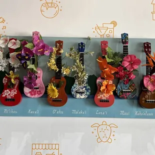 a display of hawaiian guitars and flowers