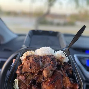 a hand holding a tray of food