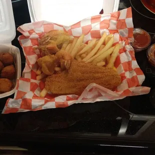 Four fried shrimp, 1 fried catfish, regular fries, hush puppies, tartar sauce, cocktail sauce.