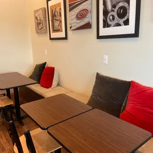 tables and chairs with red cushions