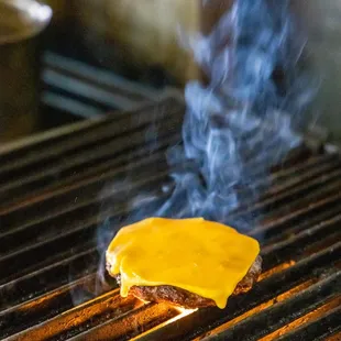 a cheeseburger on a grill