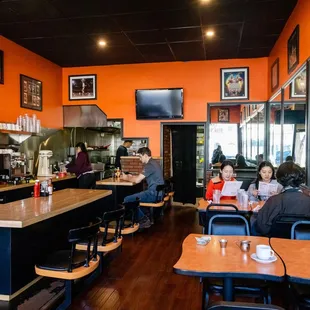 people sitting at tables in a restaurant