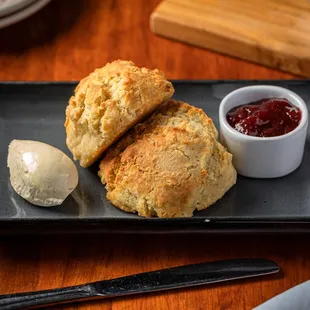 two scones and a spoon on a plate