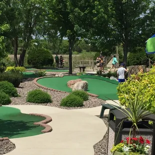 18 Holes of Luxurious Mini Golf in a Paradise atmosphere of trees, flowers, a river and fountain!