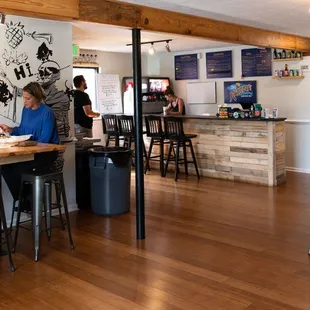 people sitting at tables in a restaurant