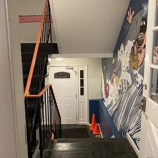 Stairs to the restaurant and the wall art